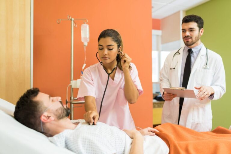 female-doctor-examining-sick-patient-with-stethoscope-while-male-doctor-analyzing-reports-hospital-1-1024x683